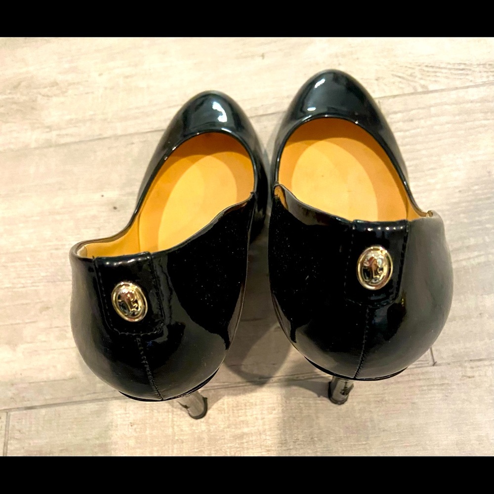 Ivanka Trump black patent heels with gold embellishments on the heal
